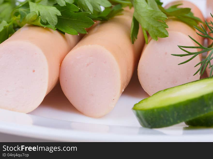 Fresh sausages on a white plate