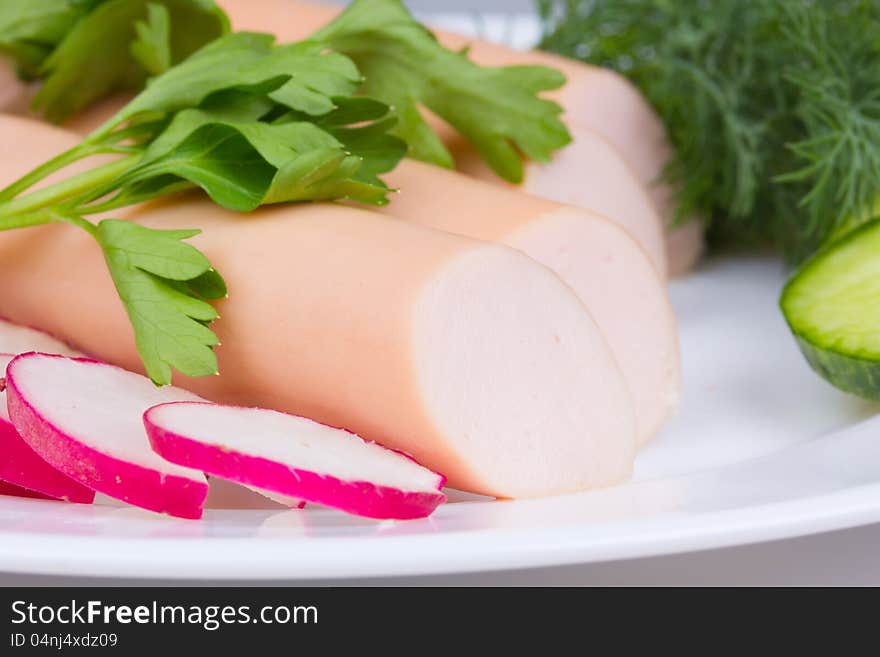 Fresh sausages on a white plate