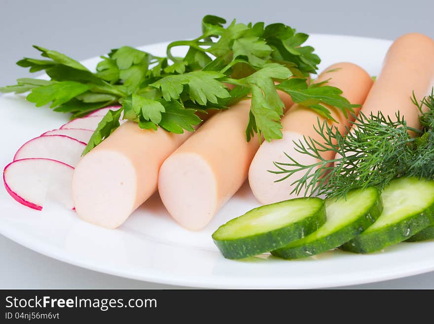 Fresh sausages on a white plate