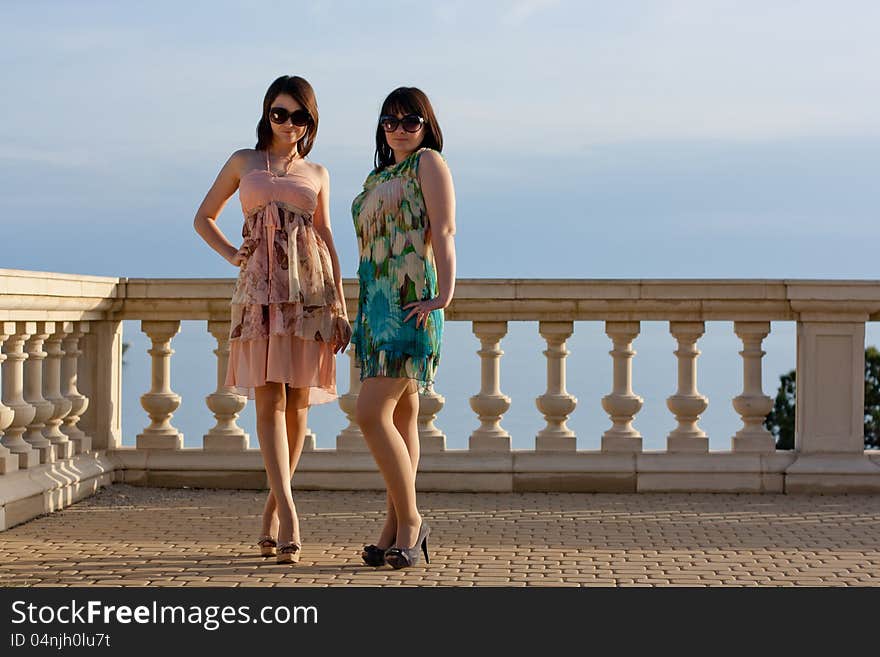 Two girls stay near the sea. Two girls stay near the sea