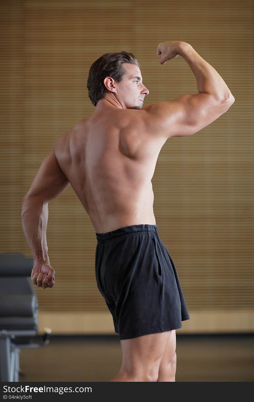 Image of a bodybuilder in a bodybuilding pose. Image of a bodybuilder in a bodybuilding pose