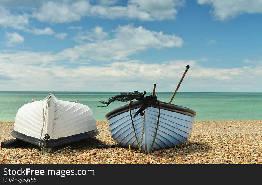 Two Boats On The Beach One Upside-down