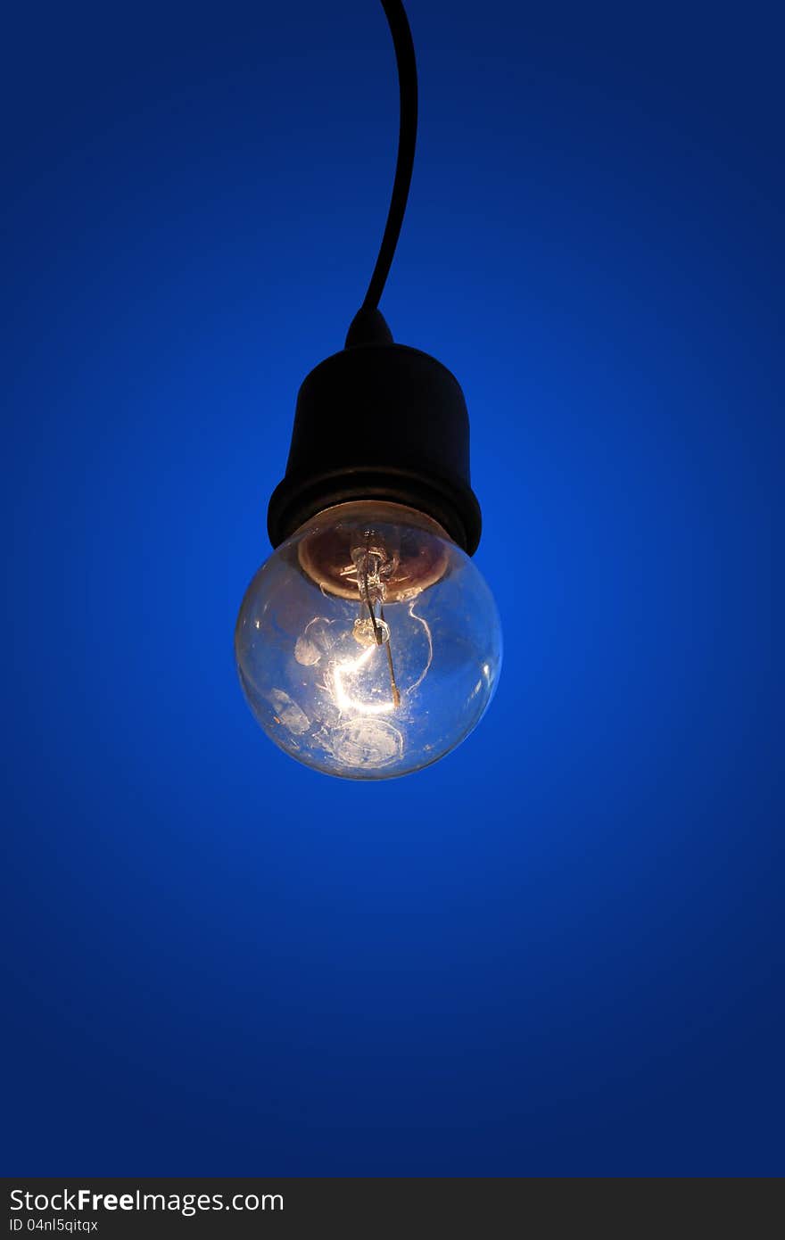 Old light bulb on blue background