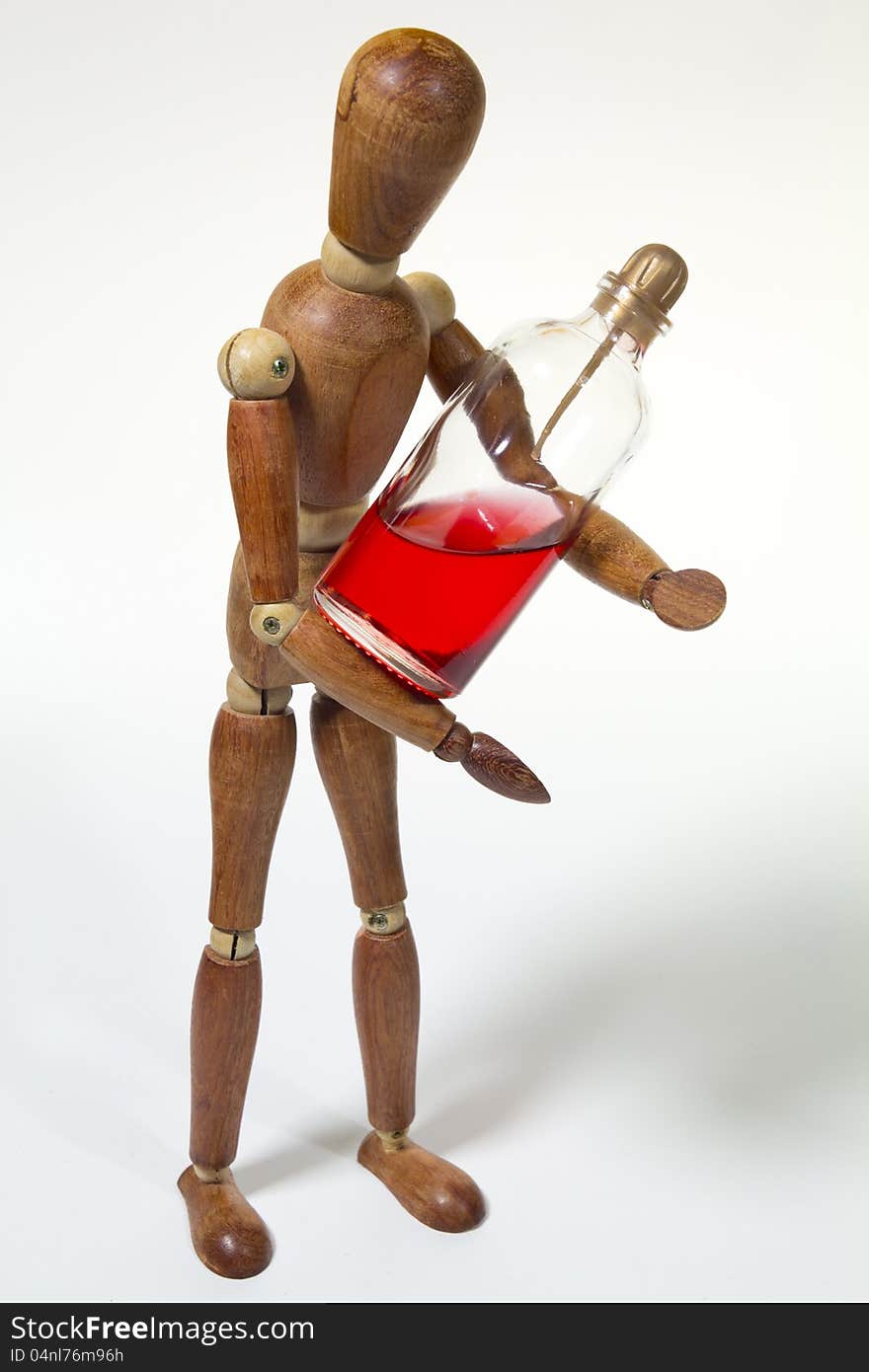 A wood doll with red parfum