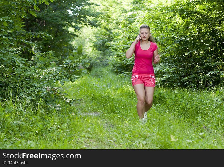 Beautiful, young girl jogging in the woods. Beautiful, young girl jogging in the woods