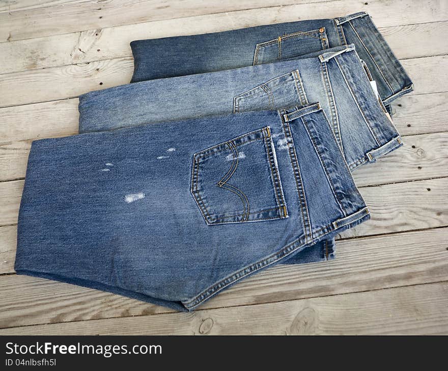 Jeans on a wooden shelf.