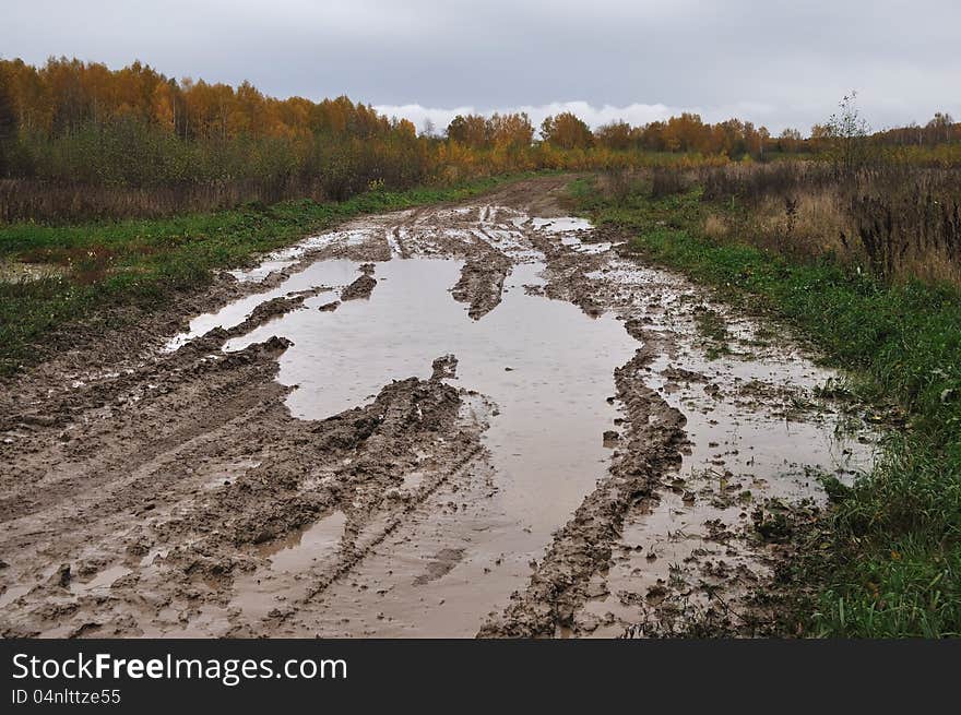 Dirty country road with puddles in the rain. Dirty country road with puddles in the rain