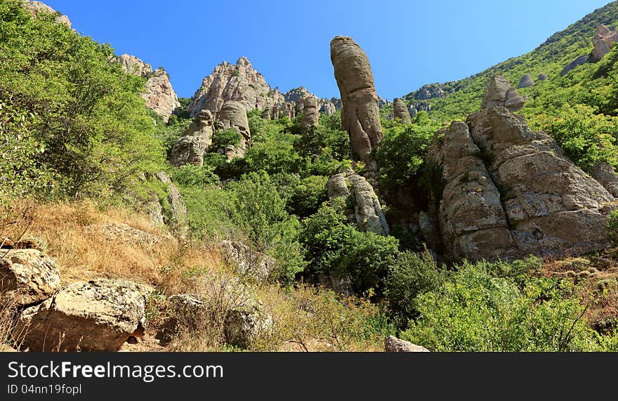 Unusual mountain formations with vegetation.cliffs of whimsical form. Unusual mountain formations with vegetation.cliffs of whimsical form.