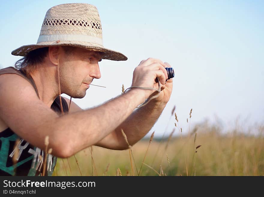 The man in a straw hat with the camera