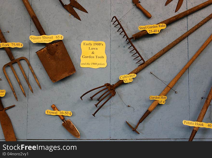 Gray wall filled with old farm tools