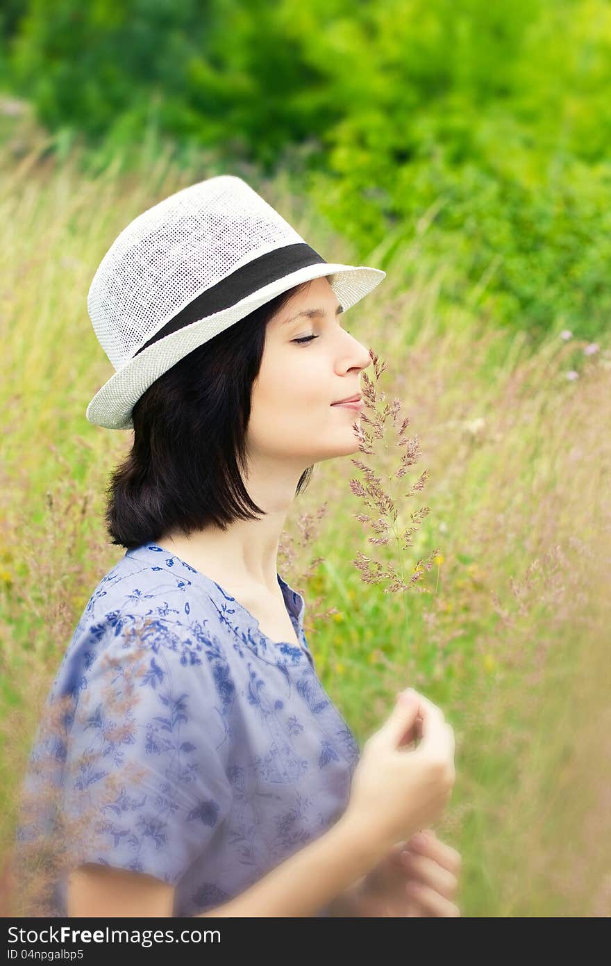 Girl smelling grass on the meadow. Girl smelling grass on the meadow