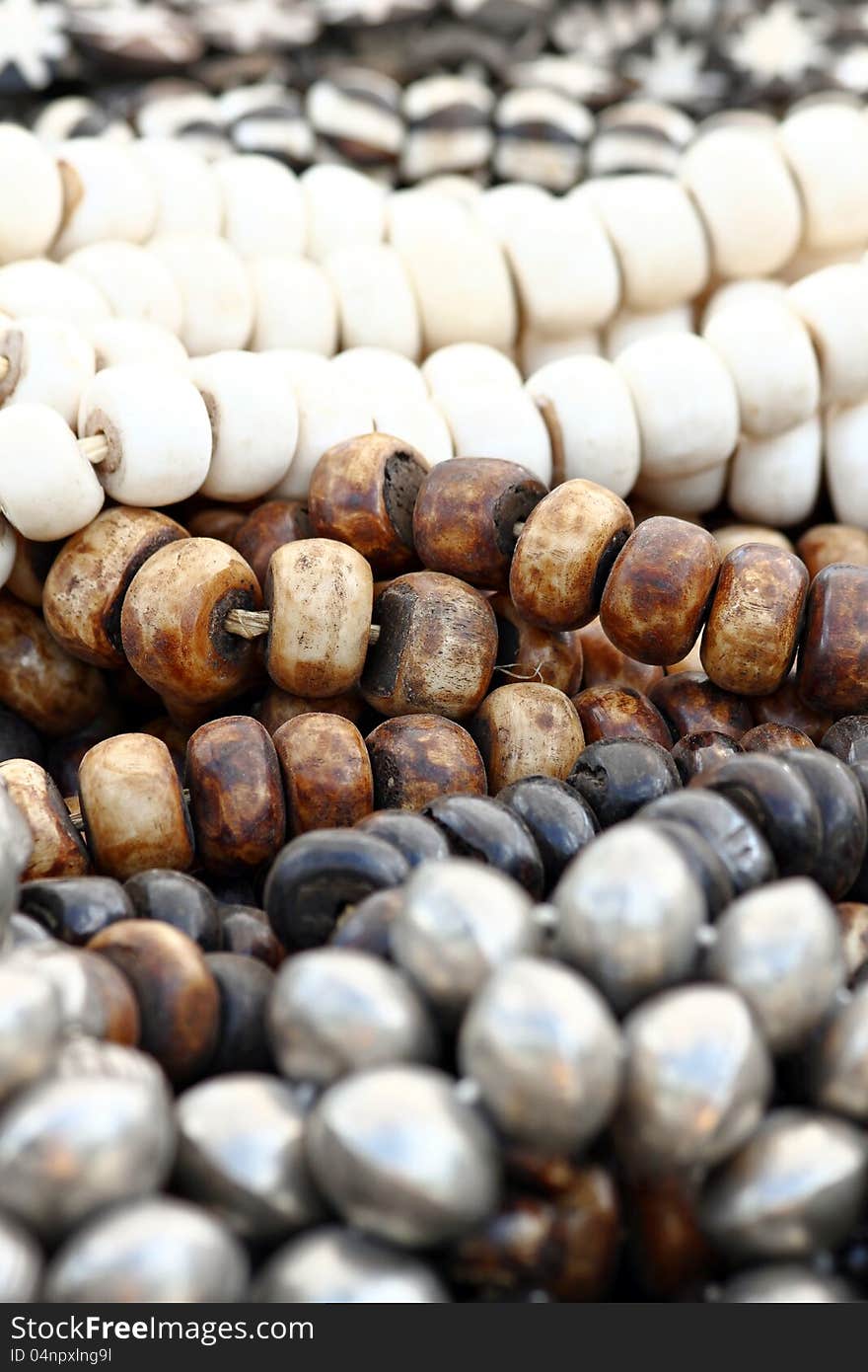 Strands of large wooden beads in black, white and gray