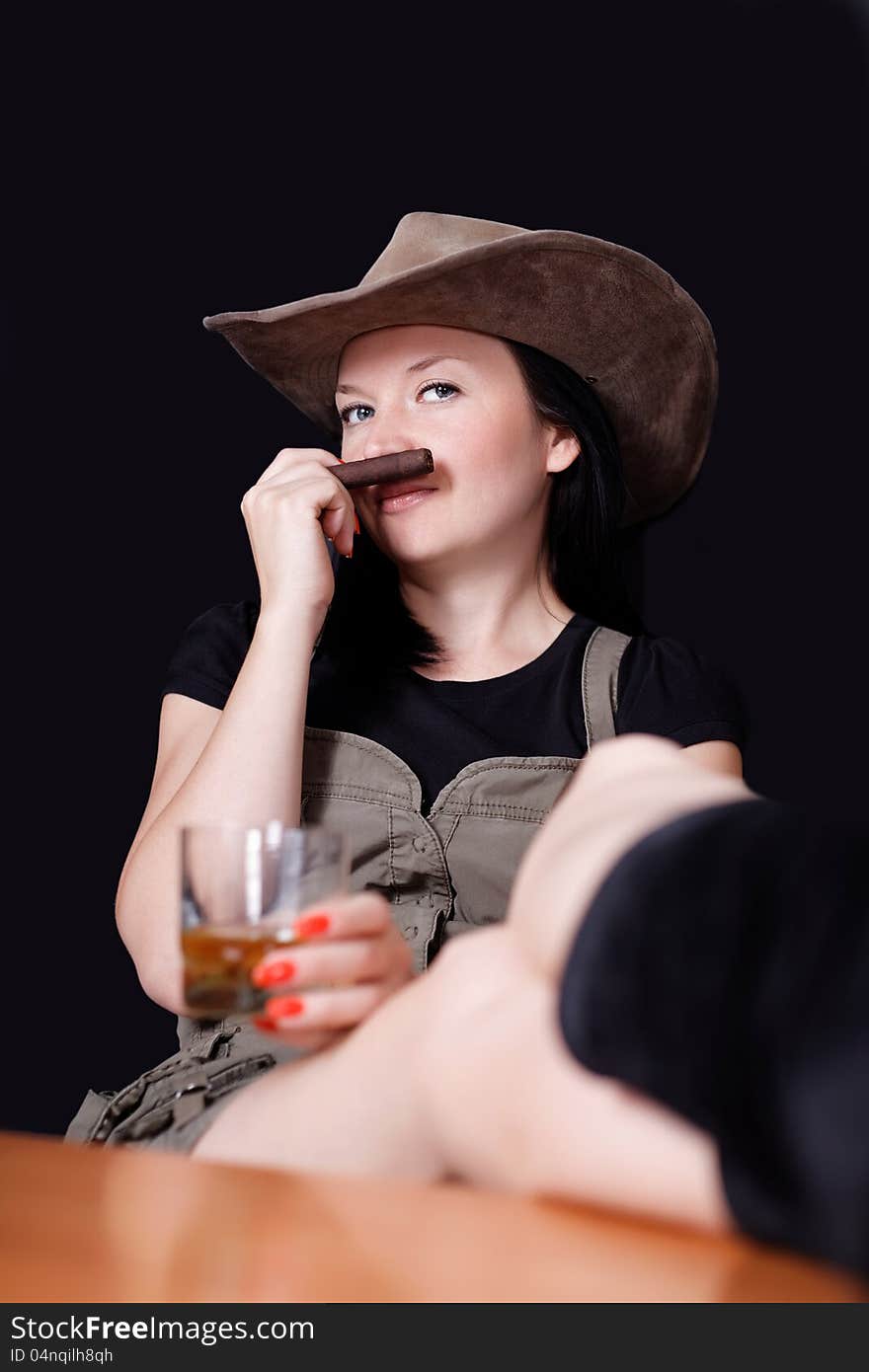 Brunette with whiskey and cigar in hand dark background