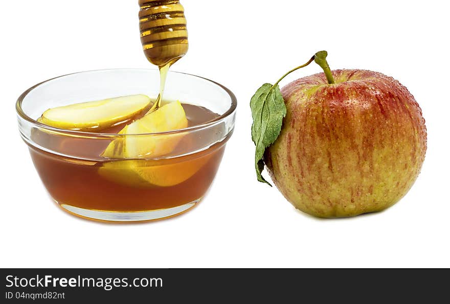 Glass with honey and apple isolated on white