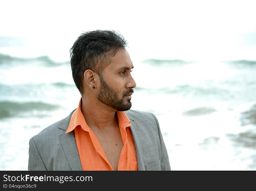 Asian indian man standing in front of beach. Asian indian man standing in front of beach