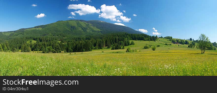 Wide-angle shot of a meadow under Babia hora mountain, at the border between Slovakia and Poland. Wide-angle shot of a meadow under Babia hora mountain, at the border between Slovakia and Poland.