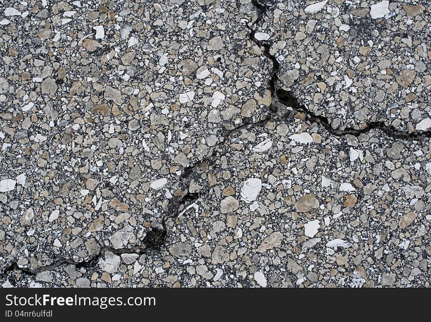 Crack in asphalt road that divides into three different directions. Crack in asphalt road that divides into three different directions