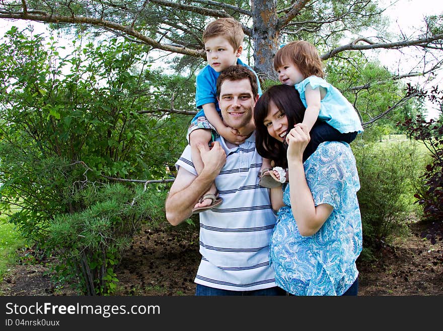 Family of four playing in park. Family of four playing in park