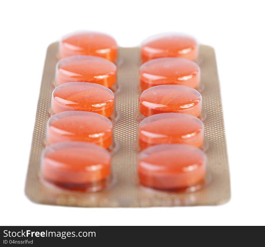 Orange pills isolated on white background. Orange pills isolated on white background