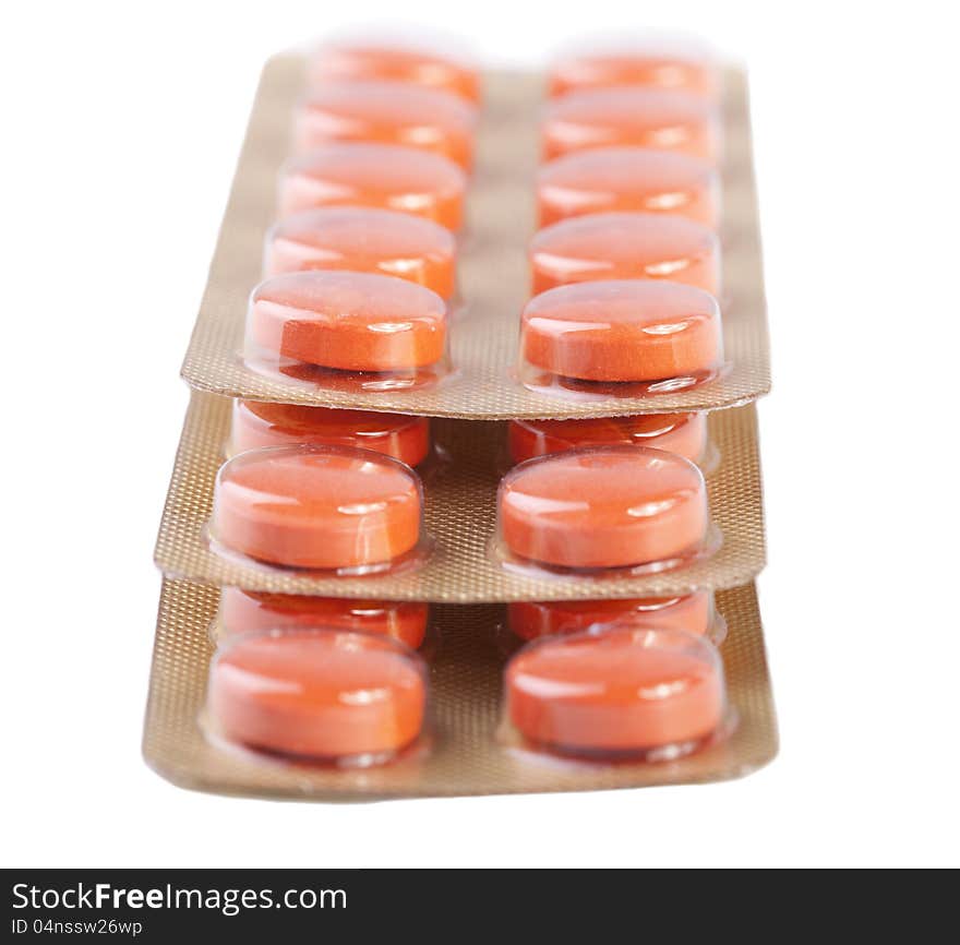 Orange pills isolated on white background. Orange pills isolated on white background