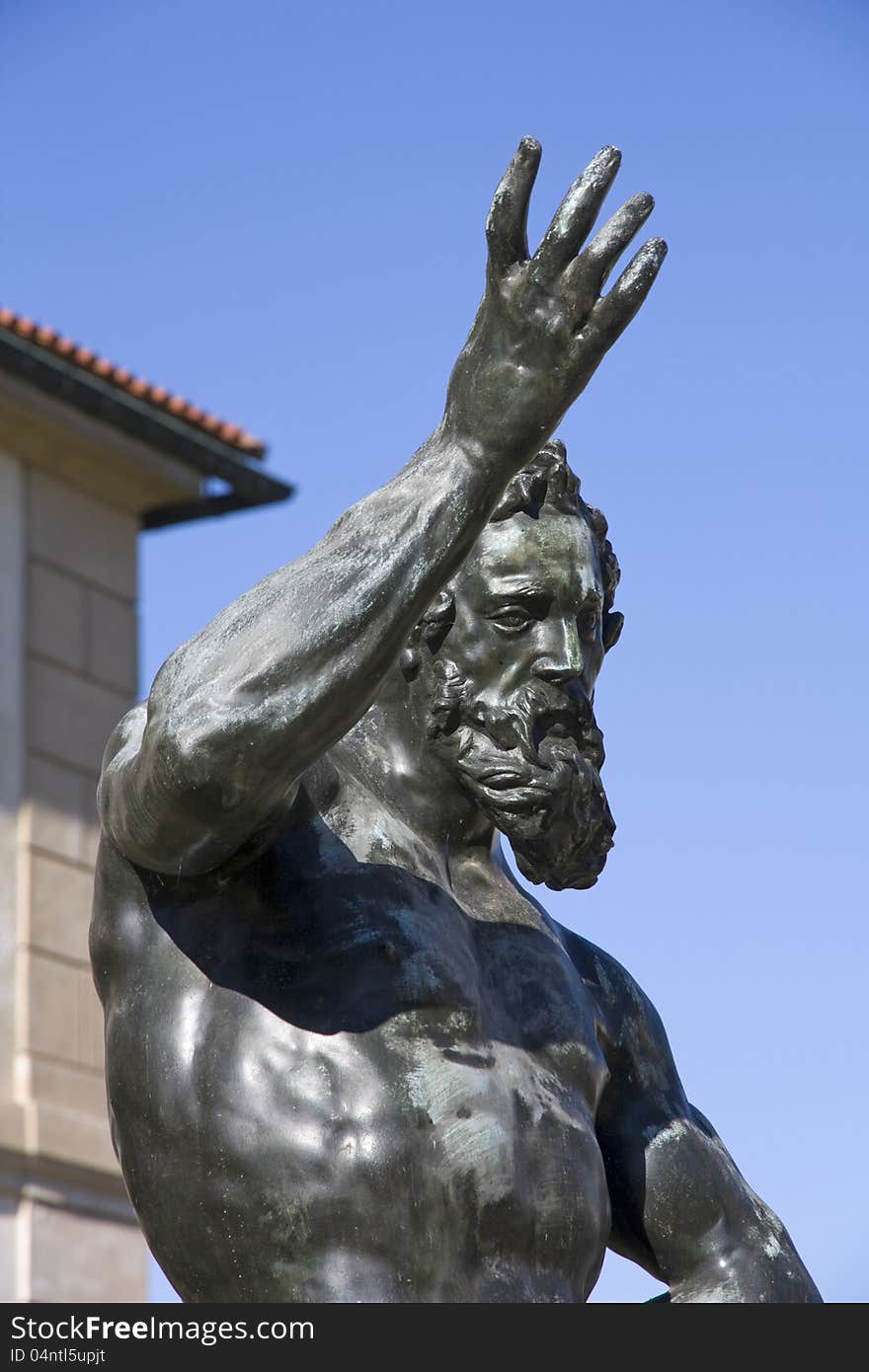 Statue of a man with a raised right hand over his head. Statue of a man with a raised right hand over his head