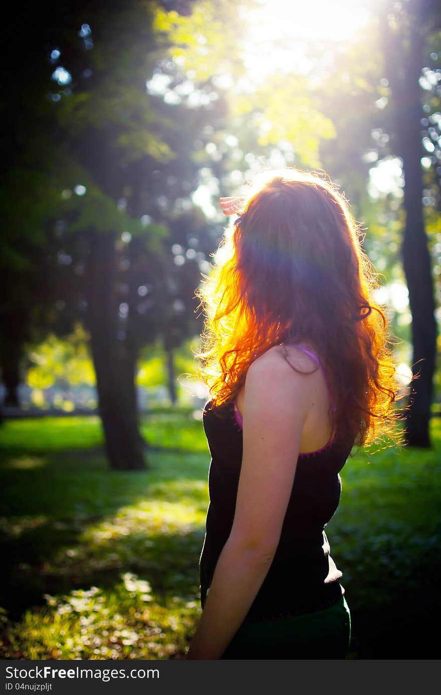 Redhead girl is looking on sunset