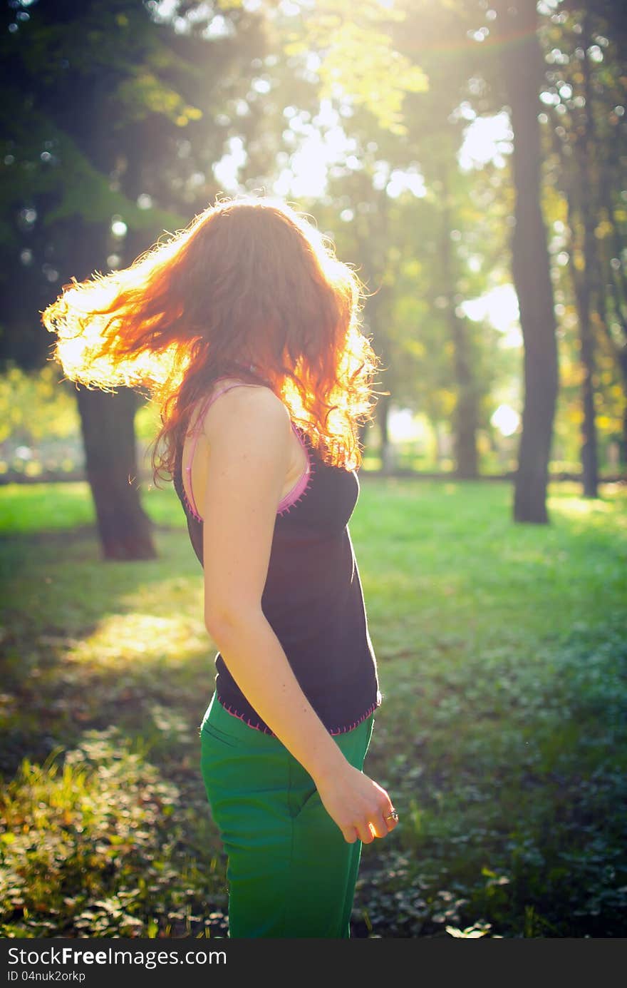 Redhead girl is jumping at the sunset