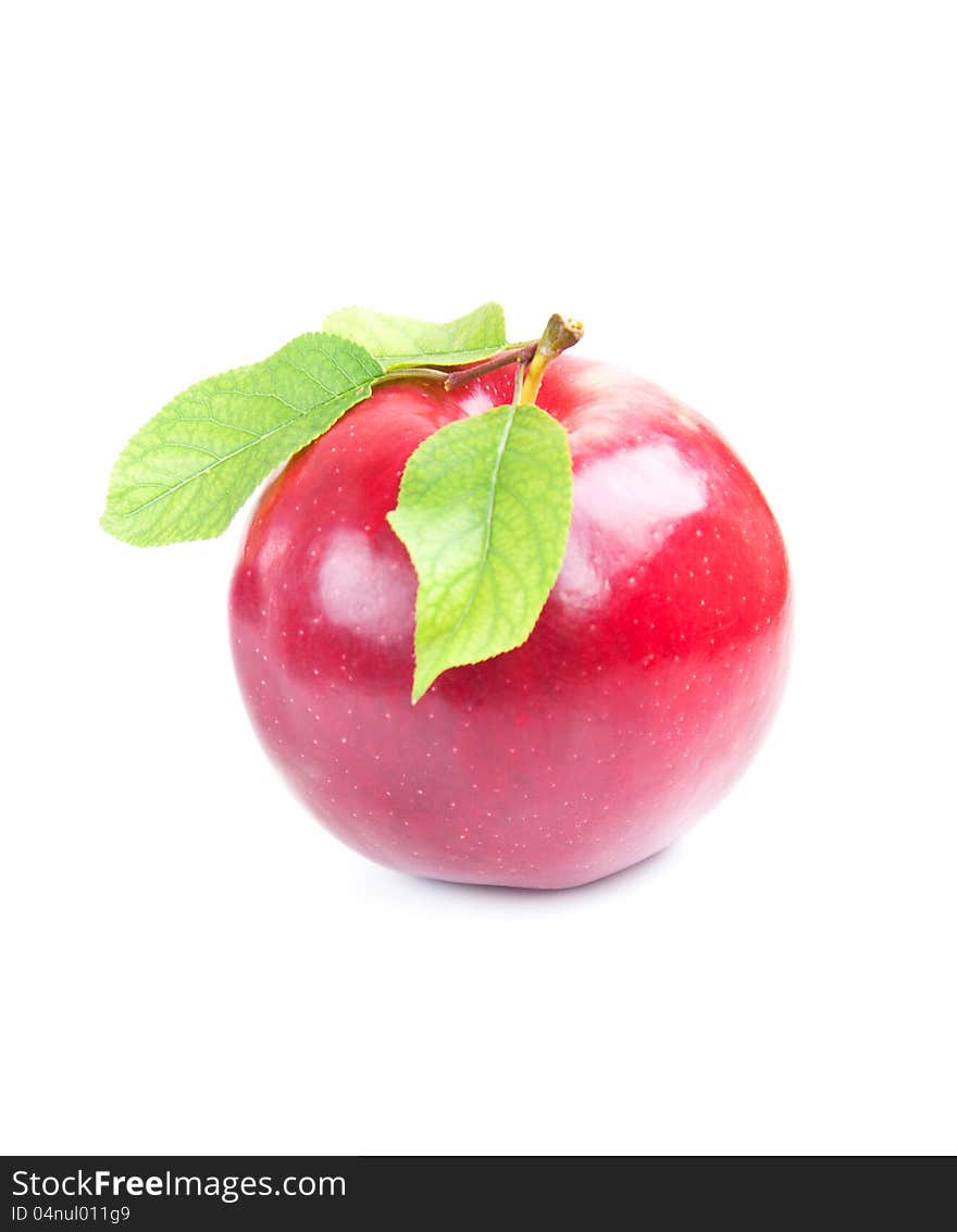 Red apple with green leaves on a white background