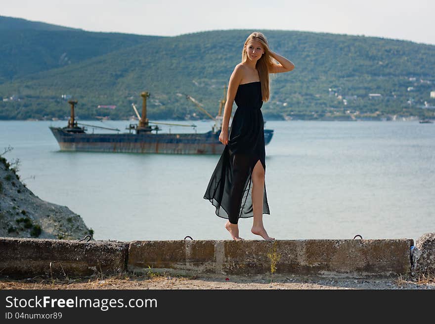 Beautiful young woman near the sea