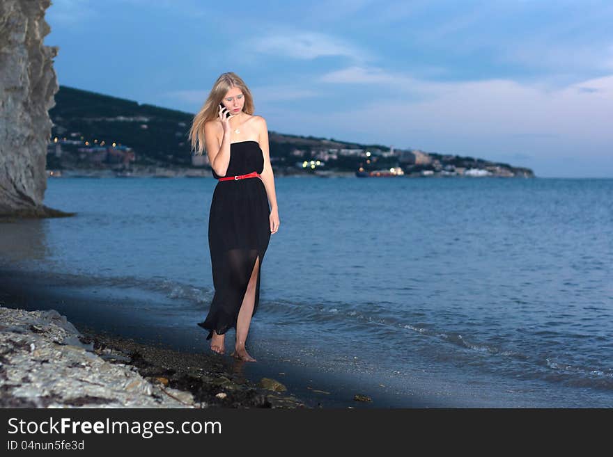 Girl go on the beach at sundown. Girl go on the beach at sundown