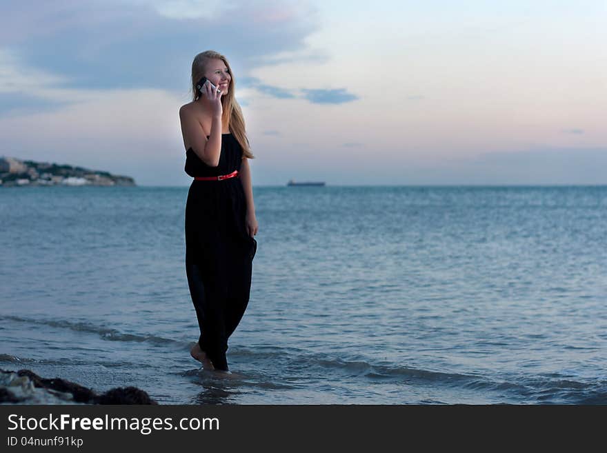 Girl go on the beach at sundown. Girl go on the beach at sundown