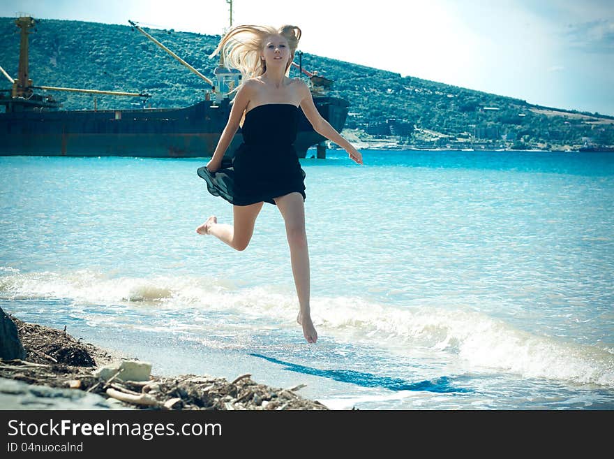 Beautiful young woman near the sea