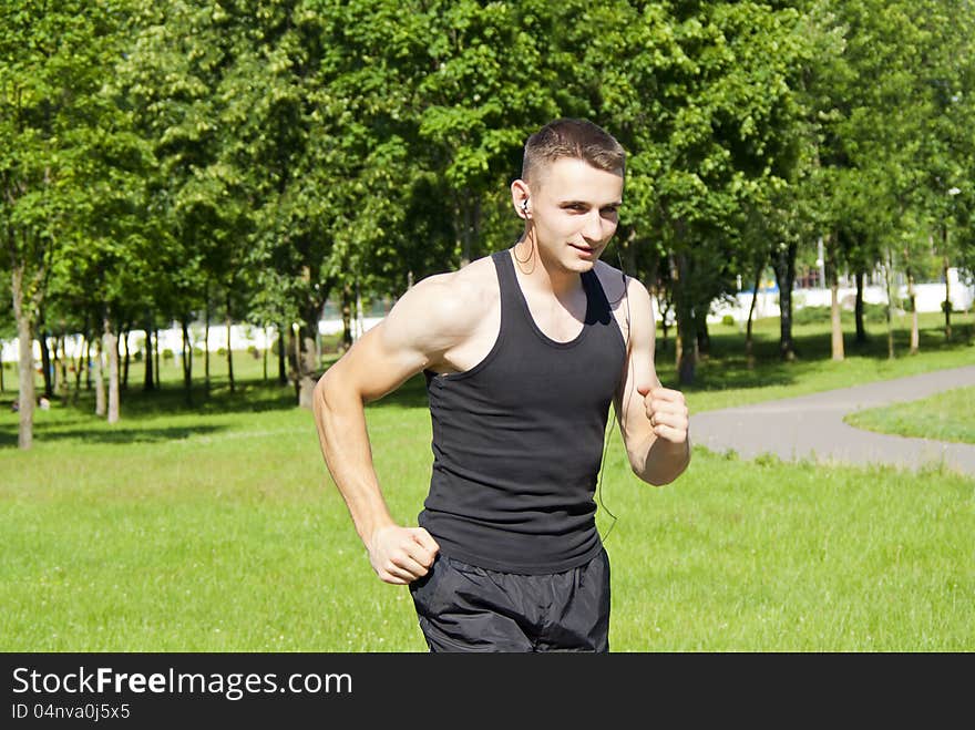 Guy athlete running with headphones