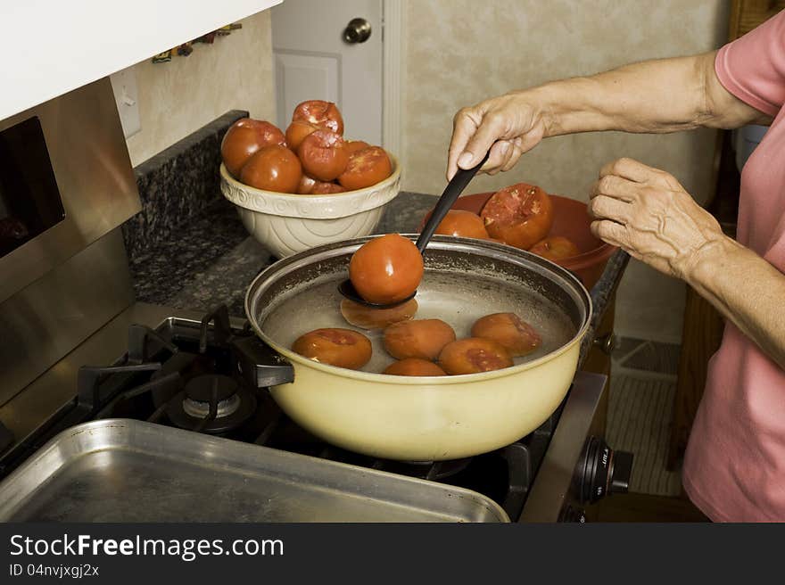 Preparing tomatoes for canning.