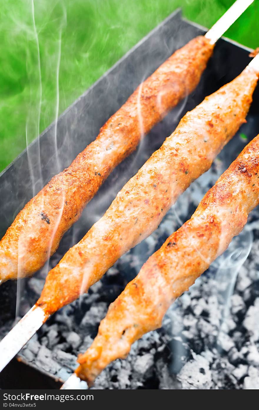 Delicious juicy meat kebab on outdoors grill. Delicious juicy meat kebab on outdoors grill