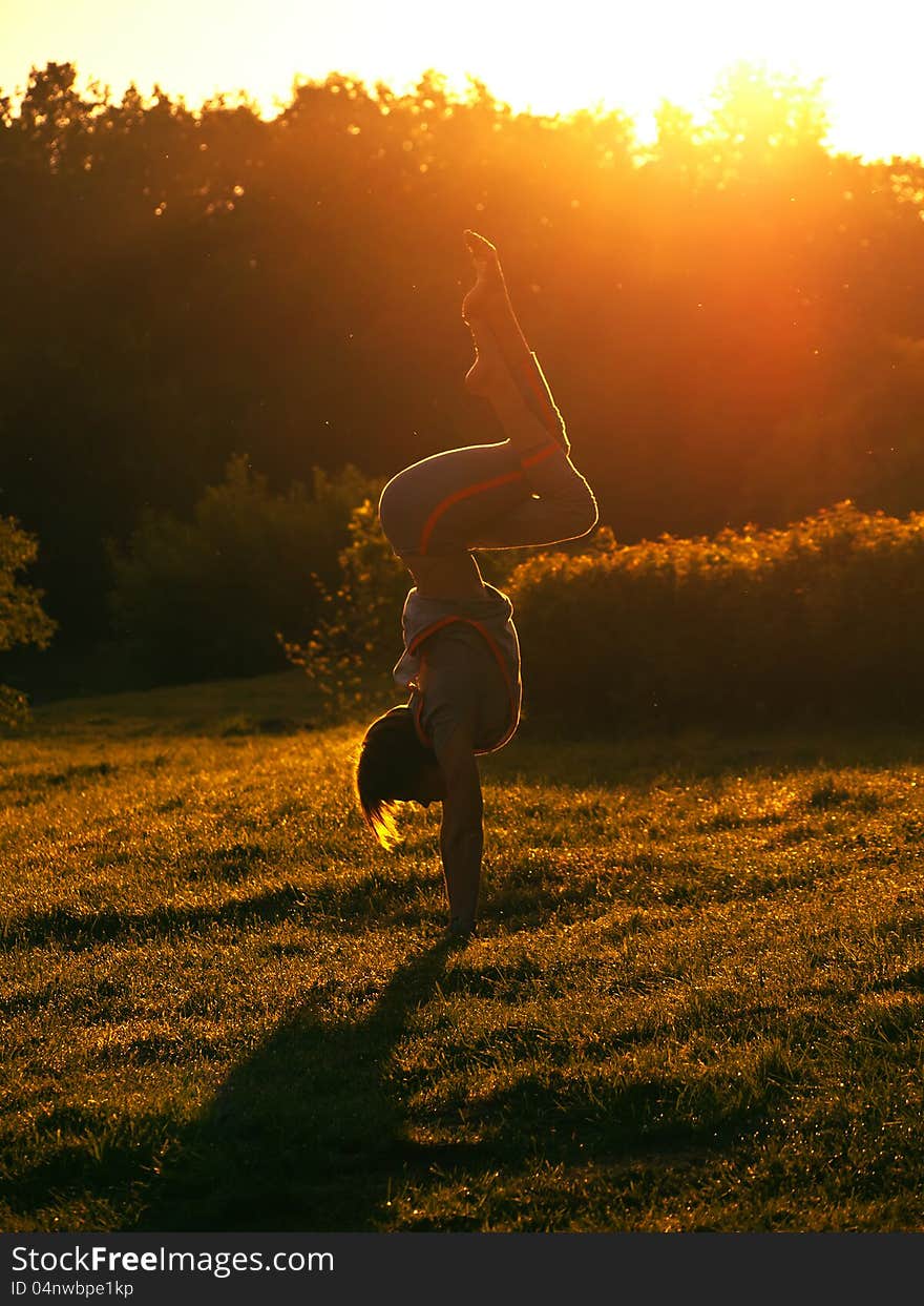 The young girl to do exercises on nature in the morning. The young girl to do exercises on nature in the morning