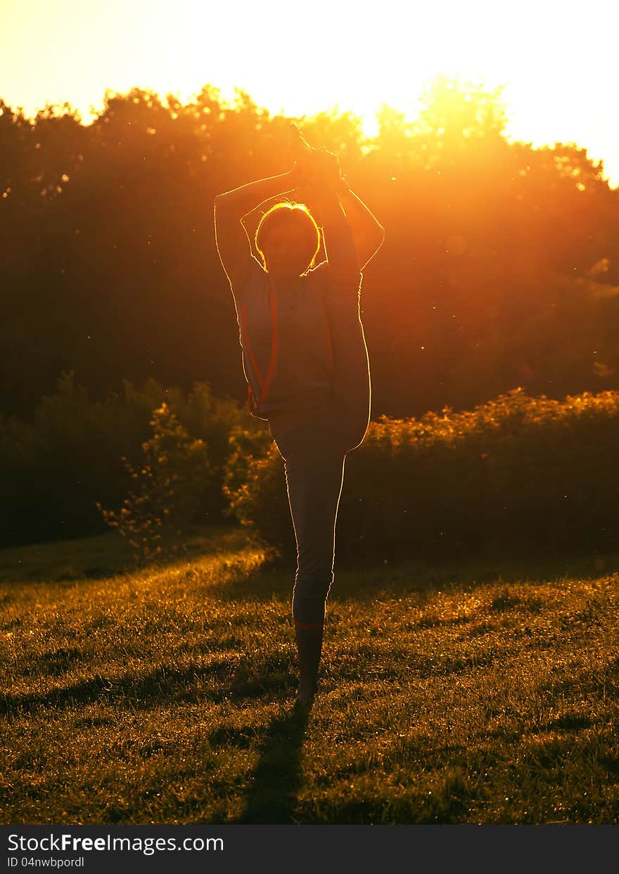 The young girl to do exercises on nature in the morning. The young girl to do exercises on nature in the morning