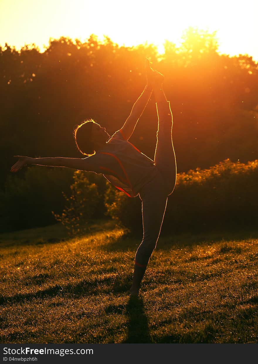 The young girl to do exercises on nature in the morning. The young girl to do exercises on nature in the morning