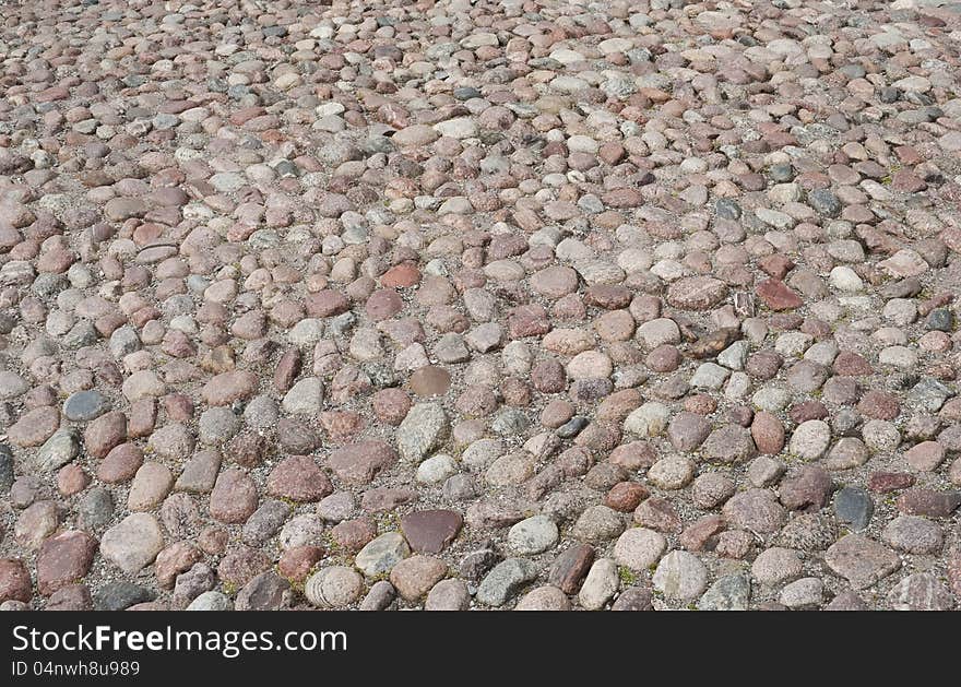 Old road paved with the cobble stones, background