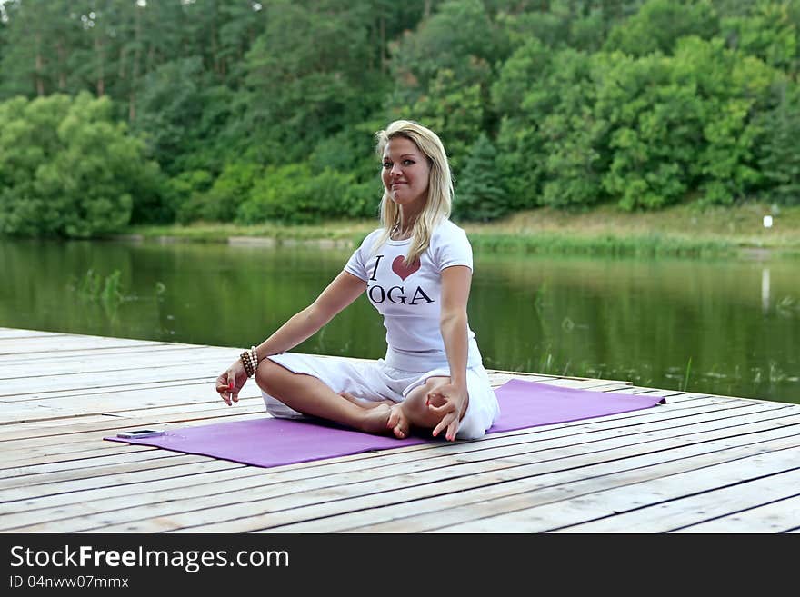 The young woman meditates outdoors