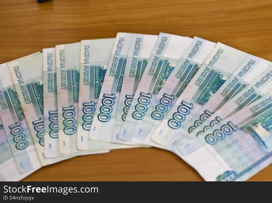 Russian rubles lie on a table a fan. Russian rubles lie on a table a fan