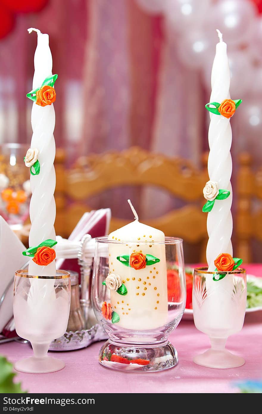 candles in candlesticks on a festive table