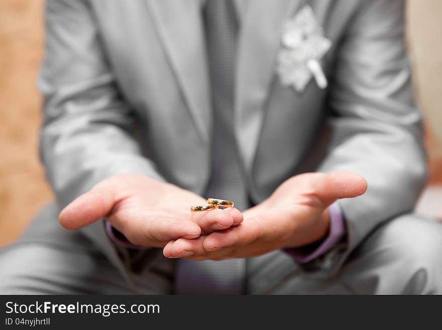 Gold wedding rings on a hand of the groom