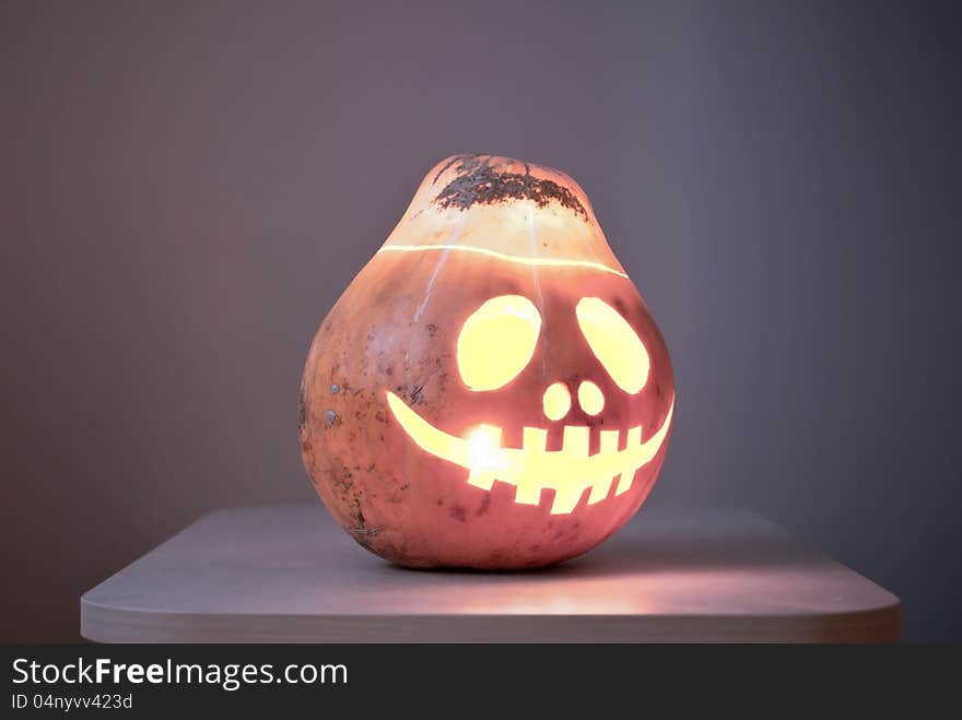 Halloween pumpkin on the table is laughing