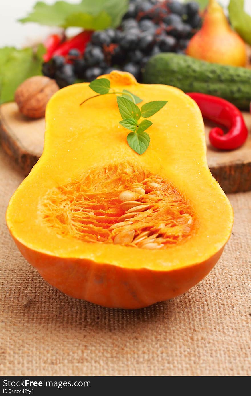 Slice of pumpkin with fresh fruits and vegetables