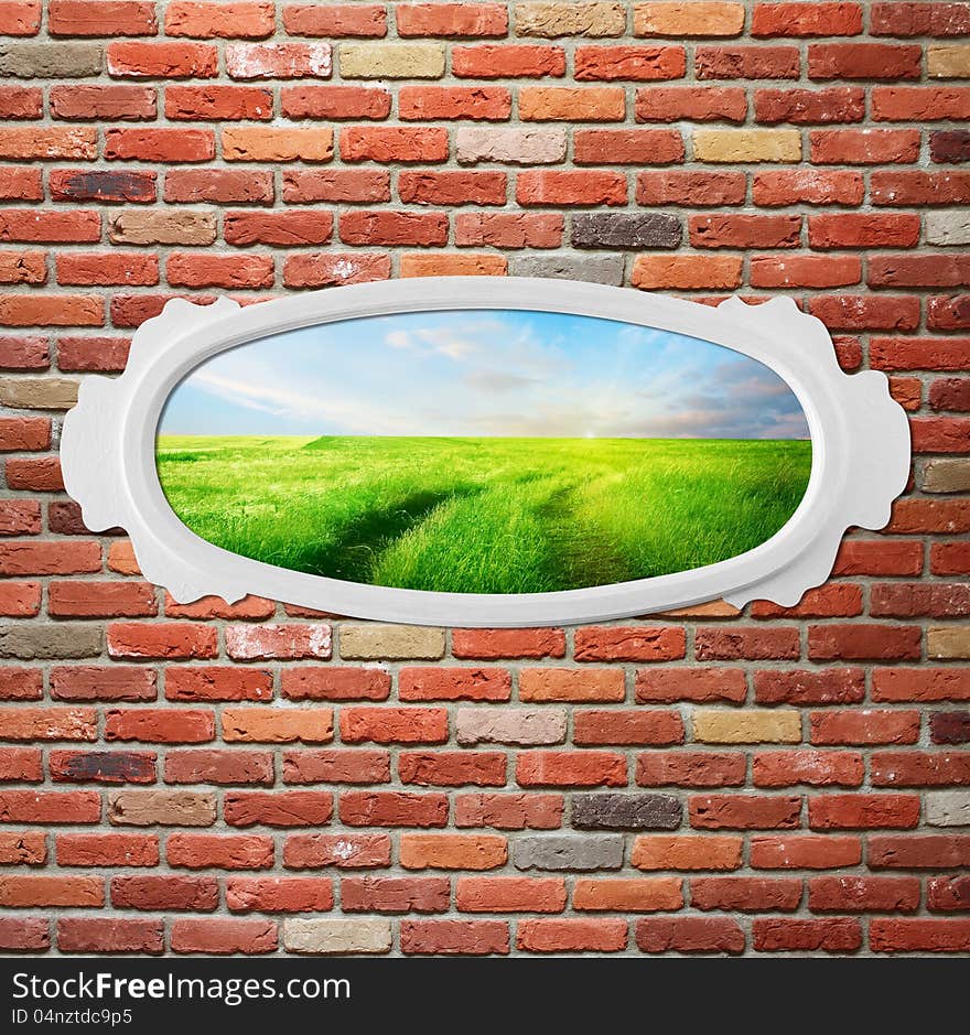 Vintage frame on brick wall with meadow