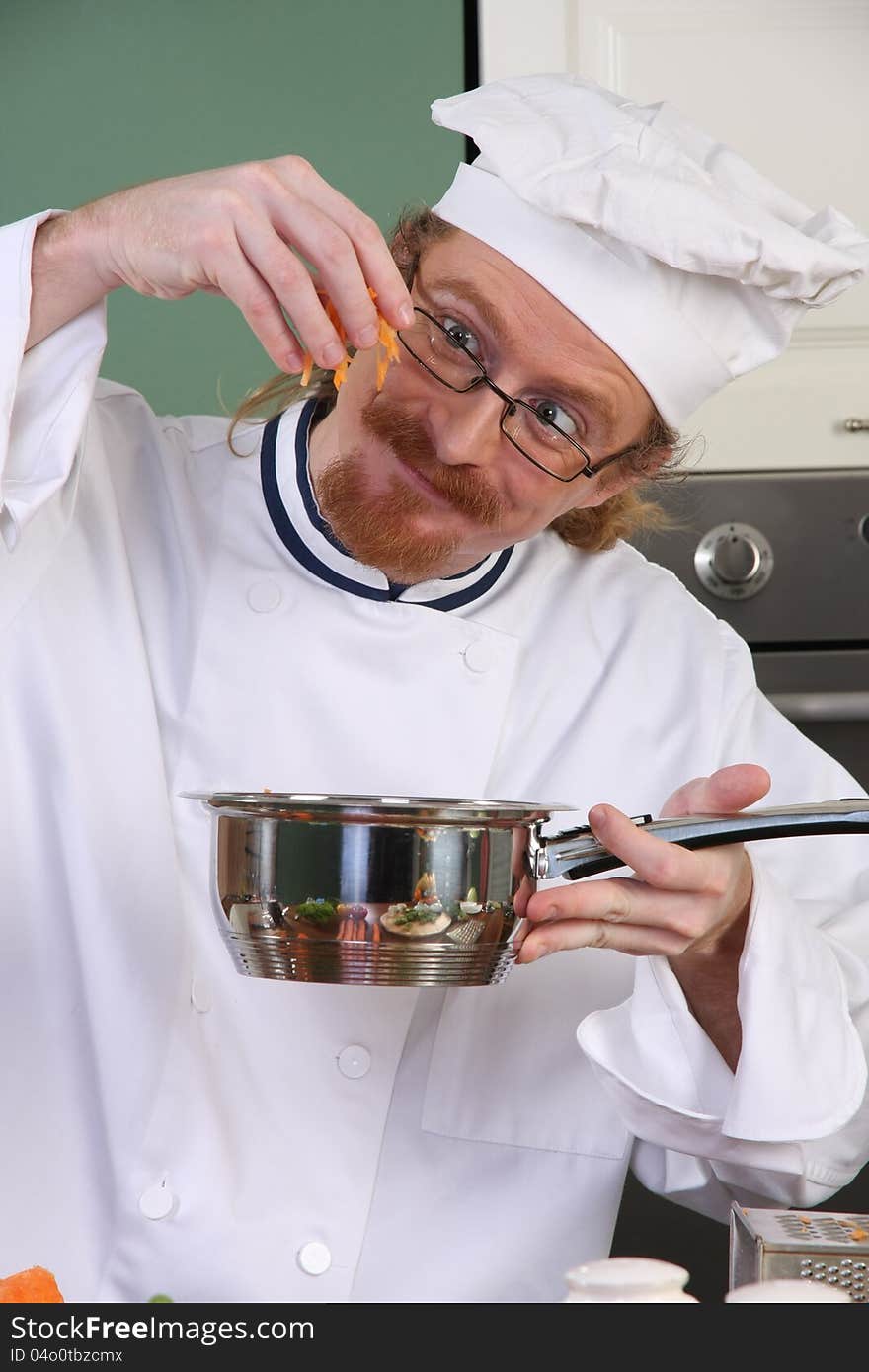 Funny young chef add carrots in the pot