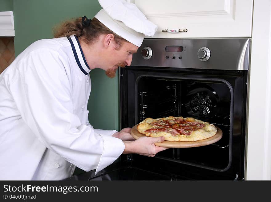 Young chef prepared italian pizza in kitchen