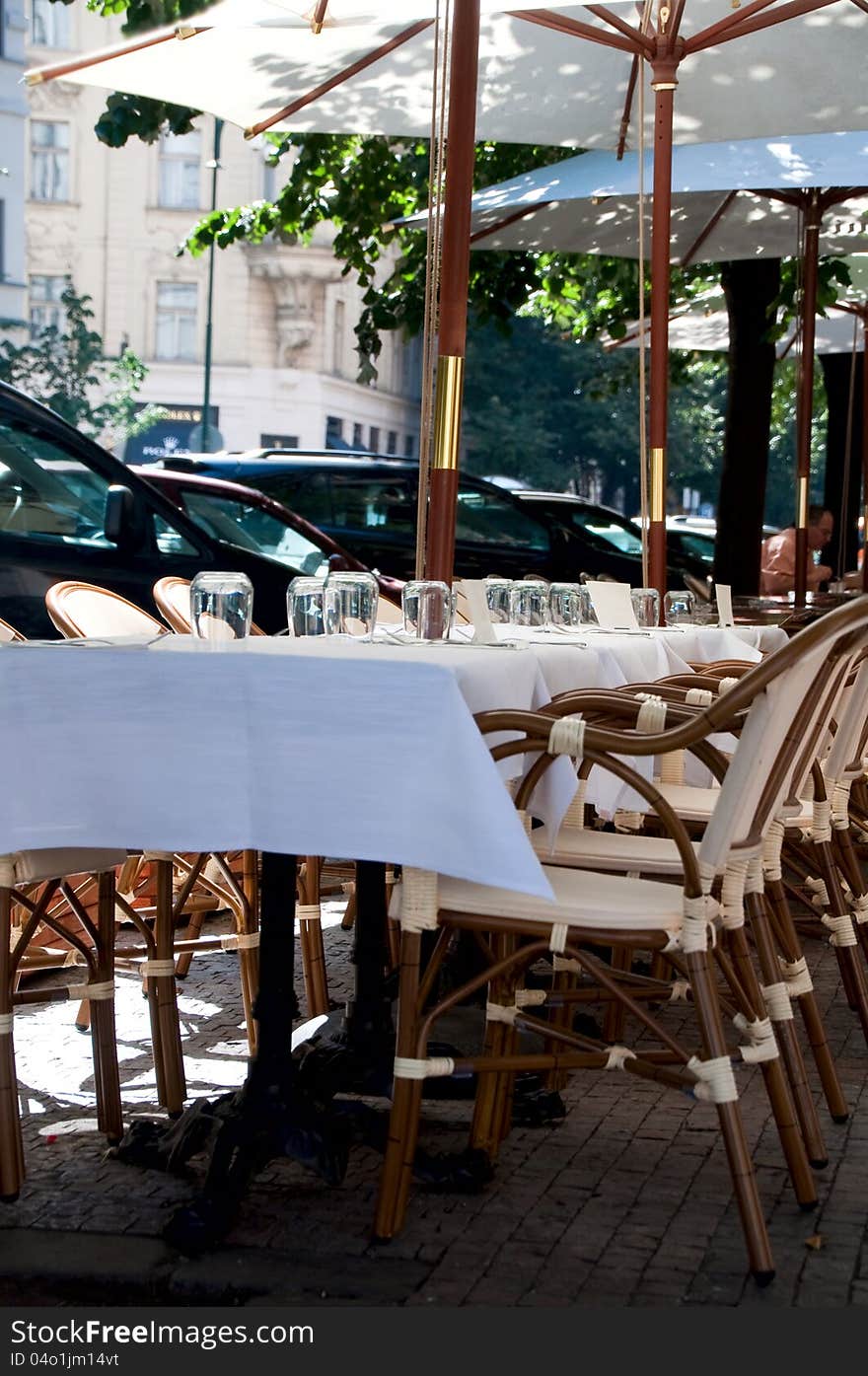 Cafe little tables on the street under awnings. Prague. Czech Republic. Cafe little tables on the street under awnings. Prague. Czech Republic.