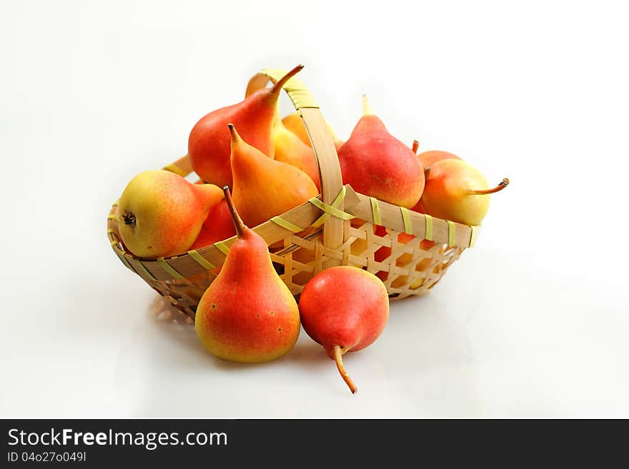 Juicy flavorful pears in basket on white